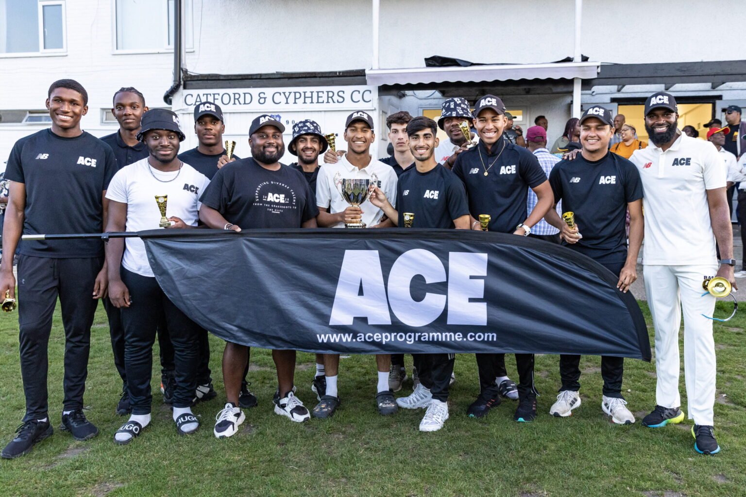 Image of ACE players posing with the ACE banner