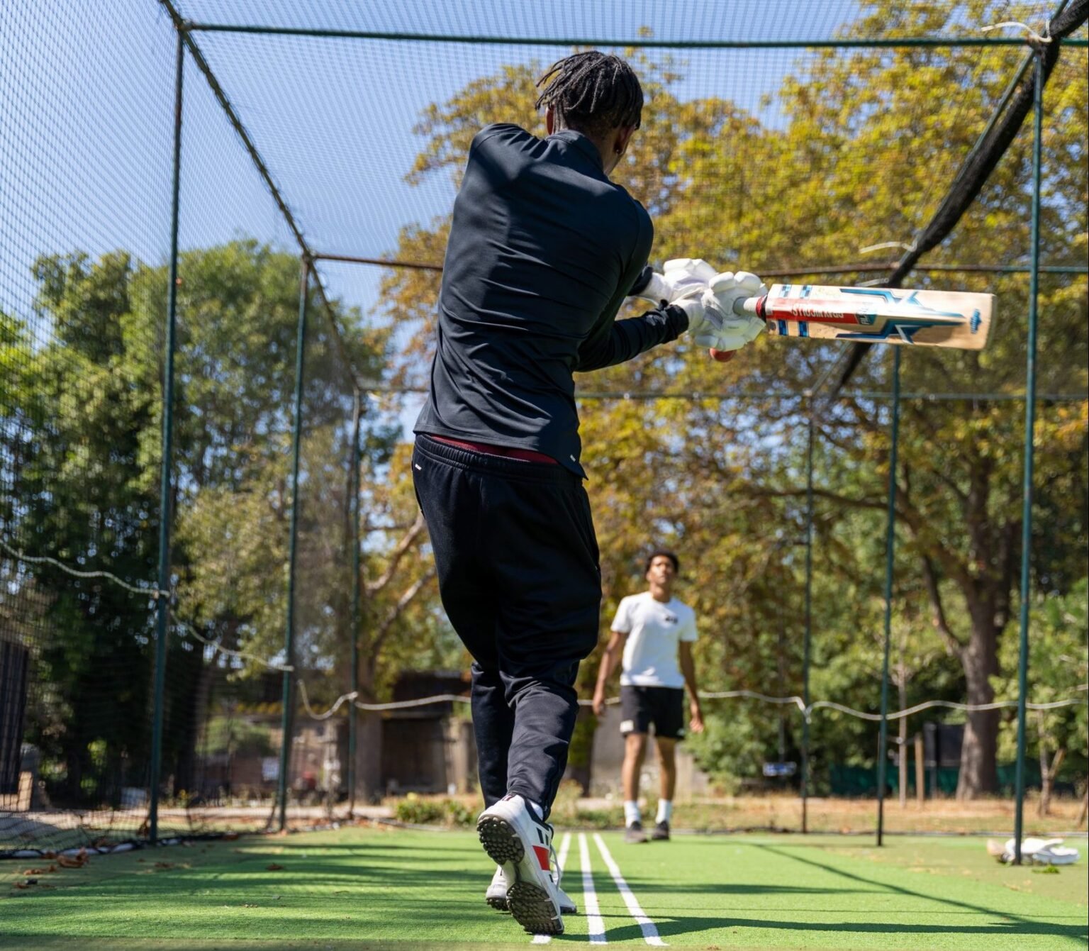 Image of ace player batting a ball into a net