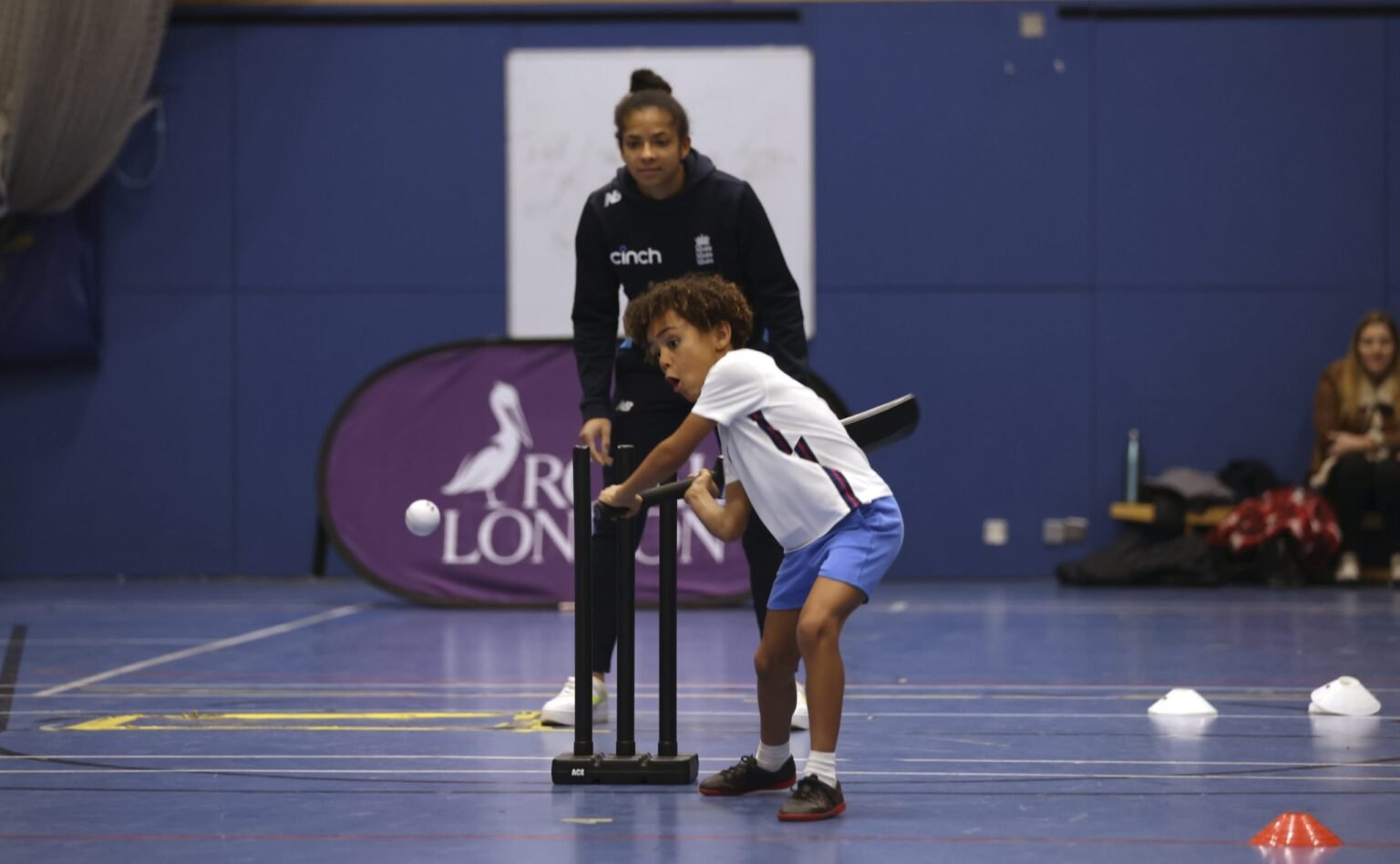 Image of child batting a ball